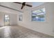 Bright living room featuring tile floors, ceiling fan, and a door to the outside at 3438 Bigelow Dr, Holiday, FL 34691