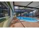 A beautiful swimming pool with a screened in patio and well maintained deck at 3438 Bigelow Dr, Holiday, FL 34691