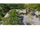 Aerial view shows the property surrounded by mature trees and includes parking and neighboring building at 4031 Bluff Oak Ct, Palm Harbor, FL 34684