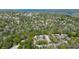 An aerial view of the property nestled amidst lush greenery and a lake at 4031 Bluff Oak Ct, Palm Harbor, FL 34684