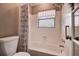 Bathroom features a shower and tub combination, a toilet, and a window at 4031 Bluff Oak Ct, Palm Harbor, FL 34684