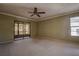 Spacious bedroom featuring neutral carpet and sliding glass door to a patio at 4031 Bluff Oak Ct, Palm Harbor, FL 34684