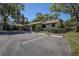 Exterior view of the condo featuring assigned parking spaces and well-maintained landscaping at 4031 Bluff Oak Ct, Palm Harbor, FL 34684