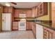 Well-lit kitchen with classic cabinetry, tiled flooring and modern appliances, refrigerator and oven at 4031 Bluff Oak Ct, Palm Harbor, FL 34684