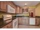 Bright kitchen with wooden cabinetry, ample countertop space, and modern white appliances at 4031 Bluff Oak Ct, Palm Harbor, FL 34684