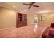 Bright living room boasts hardwood floors, vintage wood display cabinet, and ceiling fan at 4031 Bluff Oak Ct, Palm Harbor, FL 34684
