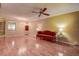 Open living room with wood floors, a ceiling fan, and a comfortable seating area at 4031 Bluff Oak Ct, Palm Harbor, FL 34684