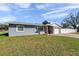 Charming single-story home with gray siding, white trim, and a well-maintained lawn at 4291 Maple Ne St, St Petersburg, FL 33703