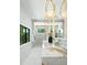 Bright bathroom featuring a double vanity, marble counters, stylish lighting, and a glass enclosed shower at 48 Sandpiper Rd, Tampa, FL 33609