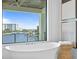 A luxurious bathroom featuring a modern soaking tub with an amazing waterfront view at 48 Sandpiper Rd, Tampa, FL 33609