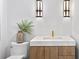 Elegant bathroom featuring a modern vanity with marble countertop and stylish light fixtures at 48 Sandpiper Rd, Tampa, FL 33609