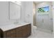 Elegant bathroom featuring a vanity with a marble countertop and glass shower, combining style and functionality at 48 Sandpiper Rd, Tampa, FL 33609