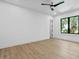 Bright bedroom with hardwood floors, ceiling fan, and a window overlooking trees, creating a serene and inviting space at 48 Sandpiper Rd, Tampa, FL 33609