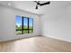 Bright, empty bedroom with a ceiling fan, natural light, and laminate floors at 48 Sandpiper Rd, Tampa, FL 33609