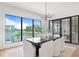 Bright dining room featuring a modern table with seating, a stylish light fixture and beautiful water views at 48 Sandpiper Rd, Tampa, FL 33609