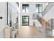 Bright foyer with high ceilings, wood floors, large windows and a modern staircase at 48 Sandpiper Rd, Tampa, FL 33609