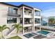 Stunning three-story home featuring balconies, a pool, a spa, and a beautifully landscaped backyard oasis at 48 Sandpiper Rd, Tampa, FL 33609