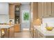 Bright and modern kitchen with light wood cabinets and views into bathroom at 48 Sandpiper Rd, Tampa, FL 33609
