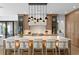 An expansive kitchen island with bar stool seating and elegant pendant lights above at 48 Sandpiper Rd, Tampa, FL 33609
