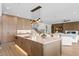Contemporary kitchen featuring a large island with bar stools and stylish lighting fixtures at 48 Sandpiper Rd, Tampa, FL 33609