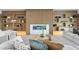 Cozy living room featuring wood paneled wall and custom shelving surrounding a modern fireplace at 48 Sandpiper Rd, Tampa, FL 33609
