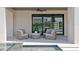 Relaxing patio area with comfortable seating, spa access, and expansive sliding glass doors for seamless indoor-outdoor living at 48 Sandpiper Rd, Tampa, FL 33609