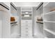 Organized walk-in closet featuring custom shelving, drawers, and hanging rods for optimized wardrobe storage at 48 Sandpiper Rd, Tampa, FL 33609