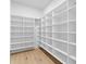 Spacious walk-in closet featuring custom shelving, providing ample storage and organization options at 48 Sandpiper Rd, Tampa, FL 33609