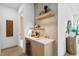 A stylish wet bar featuring custom cabinetry, elegant lighting, and modern fixtures, perfect for entertaining at 48 Sandpiper Rd, Tampa, FL 33609