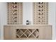 Custom wine storage featuring a wooden cabinet, marble countertop, and wine racks for stylish organization at 48 Sandpiper Rd, Tampa, FL 33609