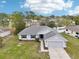 An aerial view of the home features a well-manicured lawn and neighborhood surroundings at 5134 Jenson Ave, Spring Hill, FL 34608
