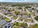 Wide aerial view of a peaceful neighborhood with well-maintained homes and abundant green space at 5134 Jenson Ave, Spring Hill, FL 34608