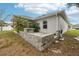 Home exterior with a decorative stone wall, mature trees, and a neatly maintained yard at 5134 Jenson Ave, Spring Hill, FL 34608