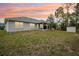 Expansive backyard featuring a covered patio, perfect for entertaining and outdoor relaxation at 5134 Jenson Ave, Spring Hill, FL 34608