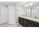 Bathroom showcasing a double sink vanity with marble countertops and a tiled floor at 5134 Jenson Ave, Spring Hill, FL 34608