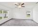 Neutral bedroom offering carpeting, two windows for natural light, and a ceiling fan for added comfort at 5134 Jenson Ave, Spring Hill, FL 34608