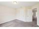 Cozy bedroom with neutral walls and gray carpet, featuring access to an adjacent room and closet at 5134 Jenson Ave, Spring Hill, FL 34608