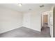 Bedroom with gray carpet with a closet and access to the hallway at 5134 Jenson Ave, Spring Hill, FL 34608