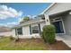 Inviting front entrance with blue door, lush green landscaping, and well-maintained pathway at 5134 Jenson Ave, Spring Hill, FL 34608