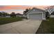 Charming home exterior features a two-car garage, well-maintained lawn, and freshly painted exterior at 5134 Jenson Ave, Spring Hill, FL 34608