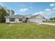 Home exterior with a two-car garage, healthy green lawn, and landscaped yard at 5134 Jenson Ave, Spring Hill, FL 34608