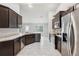 Beautiful eat-in kitchen equipped with stainless steel appliances, granite countertops, and dark wood cabinetry at 5134 Jenson Ave, Spring Hill, FL 34608