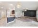 Bright living room showcasing neutral tile flooring, a breakfast bar, and an open layout for easy entertaining at 5134 Jenson Ave, Spring Hill, FL 34608