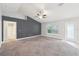 Spacious main bedroom featuring a ceiling fan, neutral paint, and an ensuite bathroom for added convenience at 5134 Jenson Ave, Spring Hill, FL 34608