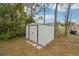 Backyard shed providing secure storage, surrounded by lush greenery and mature trees for a private setting at 5134 Jenson Ave, Spring Hill, FL 34608