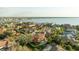 A high-angle perspective reveals a backyard pool surrounded by lush landscaping and waterfront community at 5910 La Rosa Ln, Apollo Beach, FL 33572