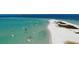 Captivating aerial view of clear turquoise waters dotted with boats, surrounded by pristine white sand beaches at 5910 La Rosa Ln, Apollo Beach, FL 33572