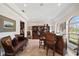 Comfortable bar area features custom wood cabinet, leather seating and plenty of room for entertaining at 5910 La Rosa Ln, Apollo Beach, FL 33572