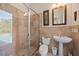 Elegant bathroom with a glass shower and travertine tile and a view of the pool at 5910 La Rosa Ln, Apollo Beach, FL 33572