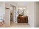 Elegant bathroom featuring a marble-lined shower, toilet, and wood vanity with marble countertop at 5910 La Rosa Ln, Apollo Beach, FL 33572